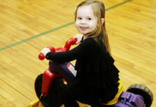 HOMEPAGE Preschool-girl on tricycle